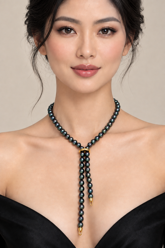 Model wearing Black Tahitian Pearl Necklace 22 Inch – 8-9.5mm Graduated Strand, 14K Gold Clasp on a soft gray background