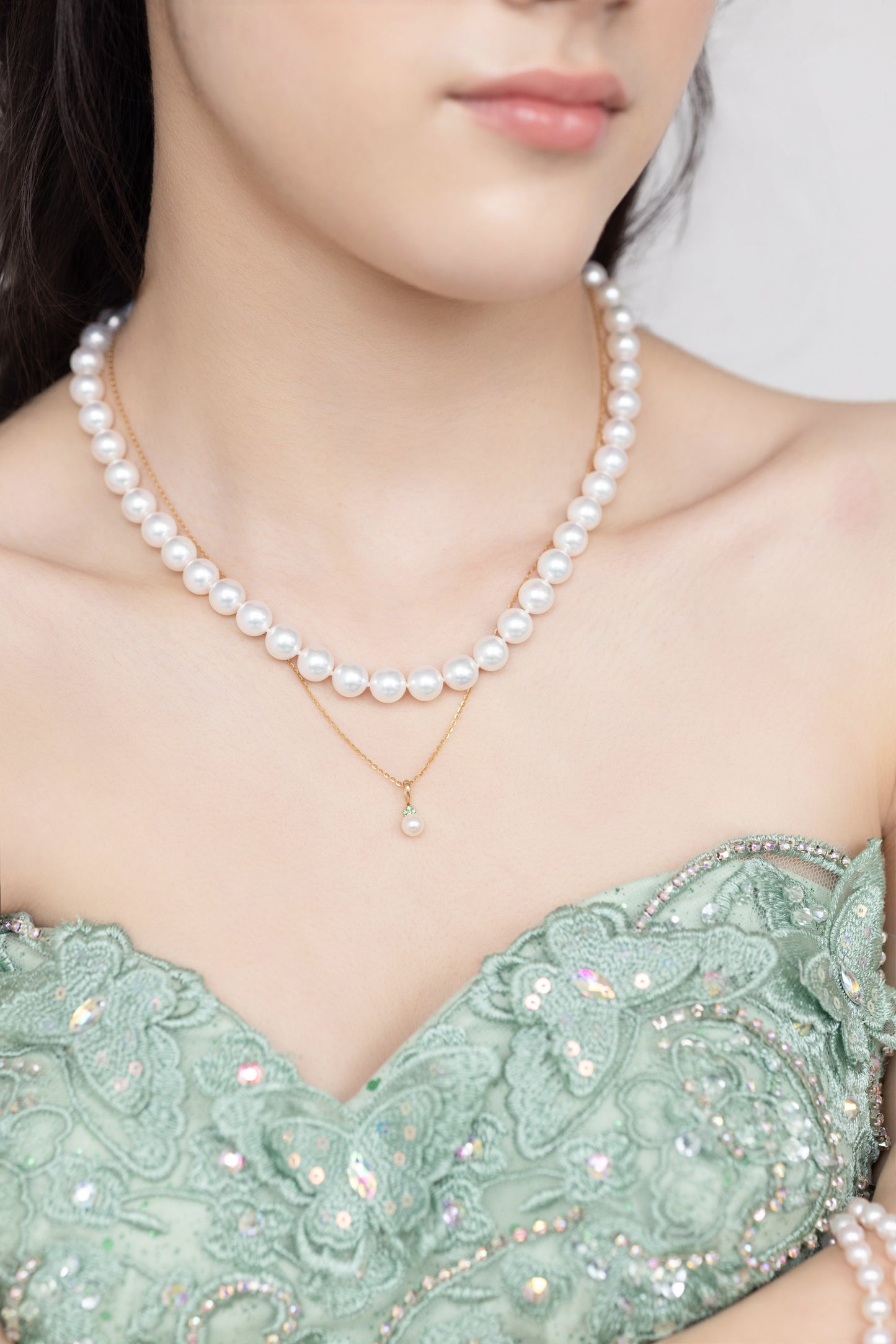 Akoya pearl emerald pendant necklace on model, collarbone length 14K gold chain