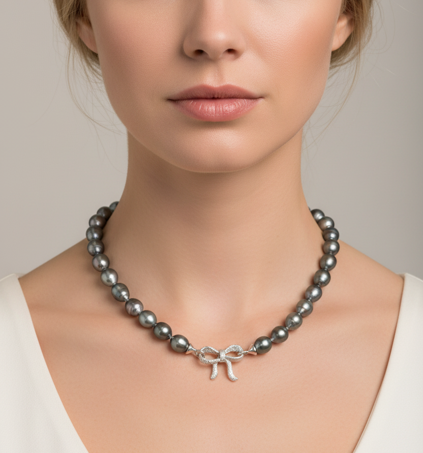 Model wearing Tahitian baroque teardrop pearl necklace, 18 inch strand, 8-12mm pearls with sterling silver bow clasp