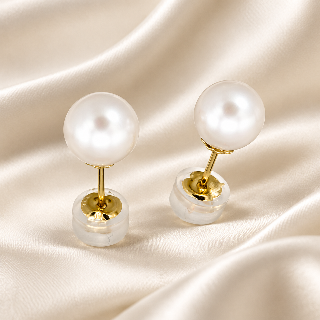 Holly Zhang 7.5mm Akoya Pearl Stud Earrings 14K Gold on a cream-colored satin background