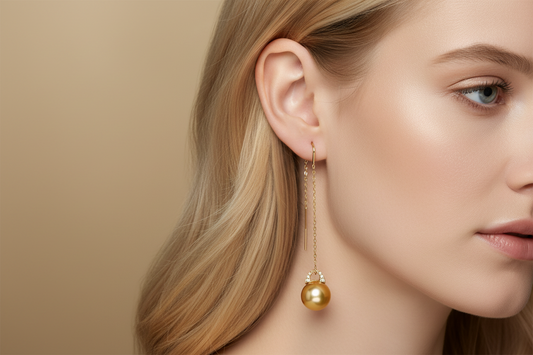 Golden South Sea pearl threader earrings with 18K gold diamond bails on blonde model