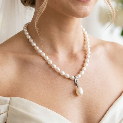 Model wearing white freshwater pearl necklace with teardrop sterling silver pendant, Holly Zhang