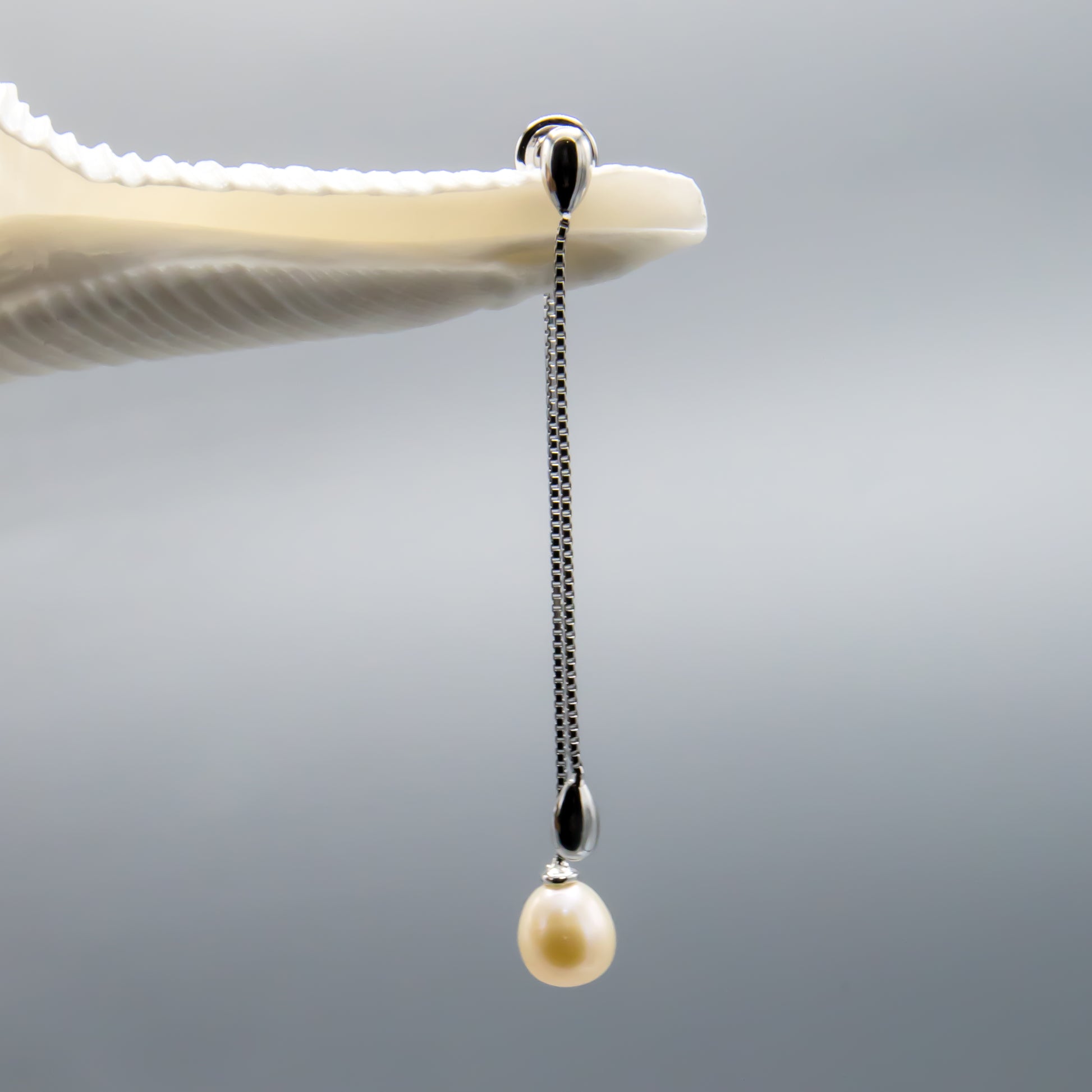 Peach teardrop pearl earrings, versatile jacket design, lifestyle view