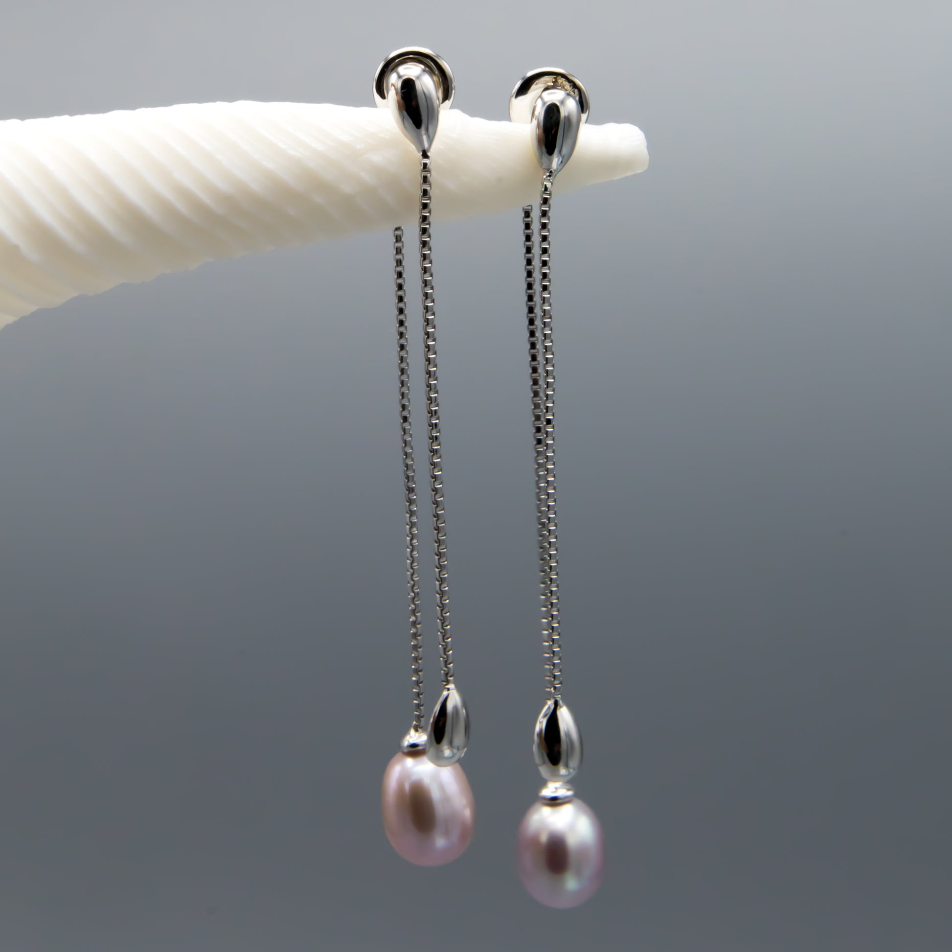 Sterling silver pearl earring jackets close-up, mauve teardrop freshwater pearls