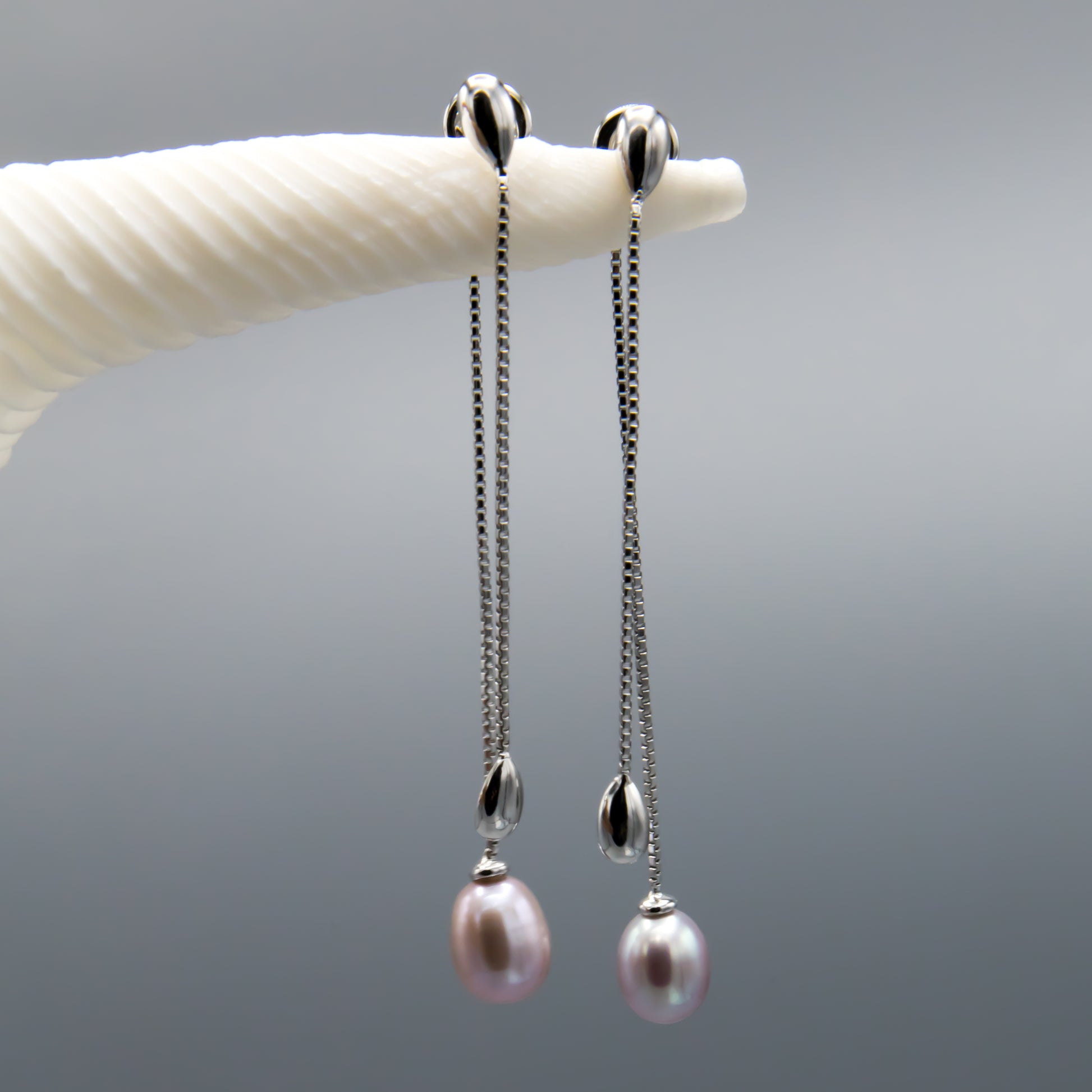 Mauve freshwater pearl earring jackets lifestyle shot, elegant dangle design