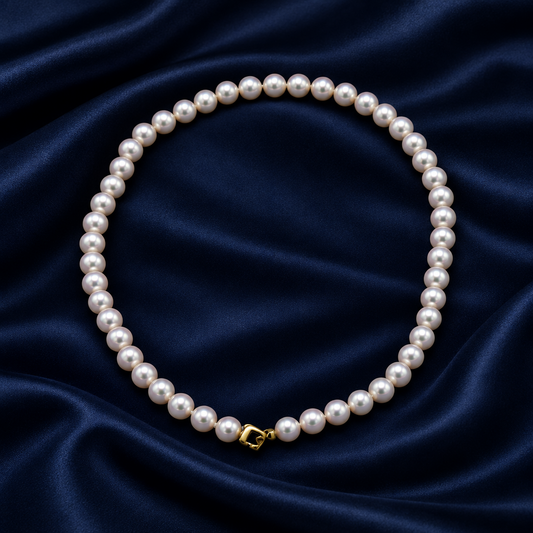 Hanadama Akoya Pearl Necklace – 8-8.5mm Certified Grade, 14K Yellow Gold Diamond Clasp on a blue satin background