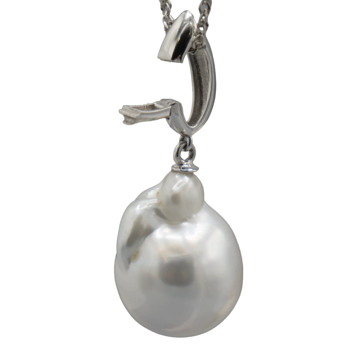 A single white baroque south sea pearl enhancer pendant in a silver clasp, shown against a white background--clasp open left side view.