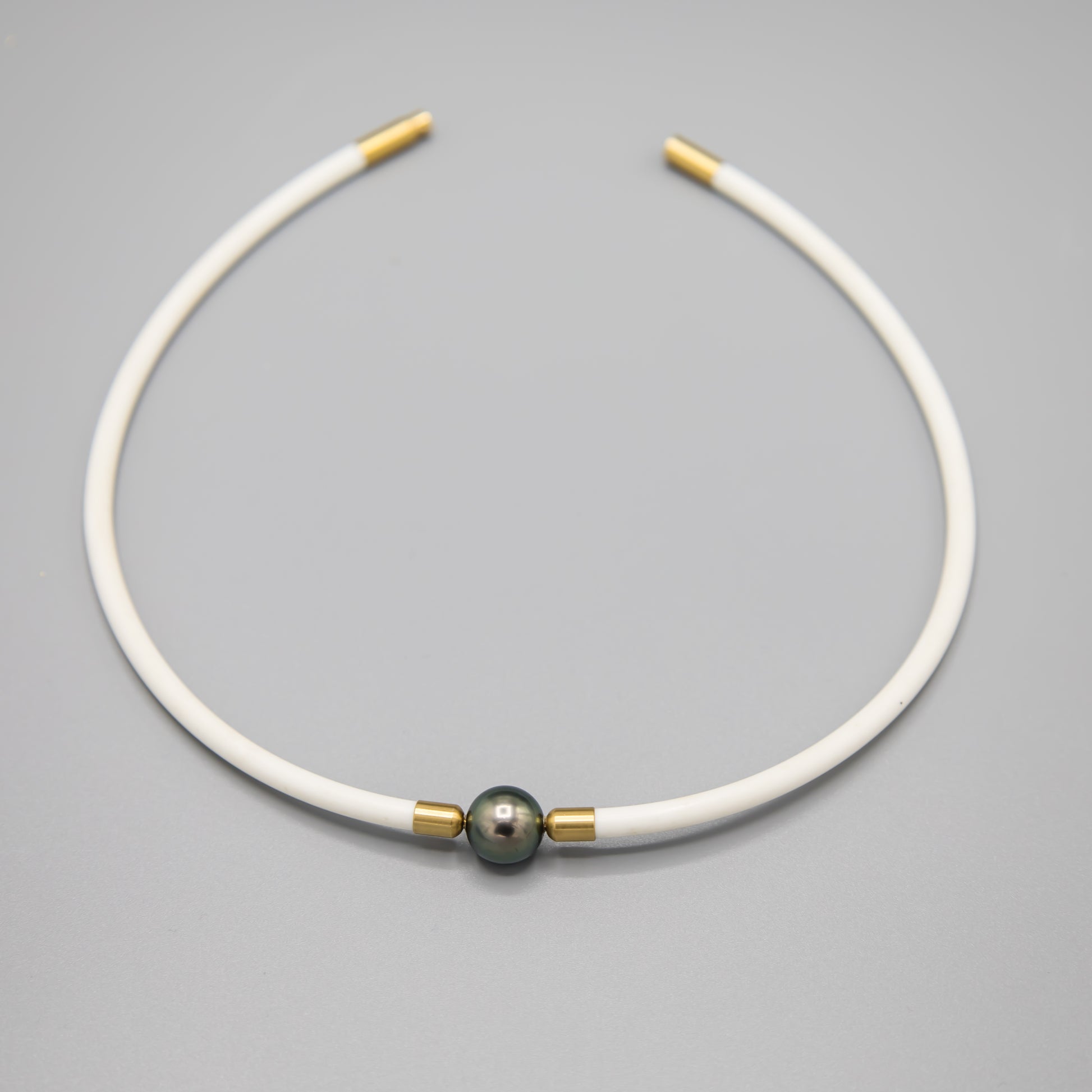 11.5mm Tahitian pearl choker necklace on white rubber cord with 14K gold clasp - closeup of pearl