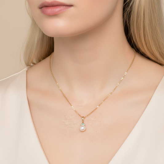 Akoya pearl and emerald pendant necklace worn on model, 18-inch 14K gold chain