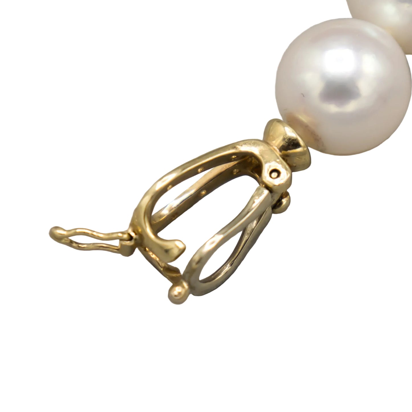 Macro detail of the open 14K yellow gold lariat clasp hardware on the Holly Zhang Japanese Akoya pearl necklace, showing the clasp mechanism.