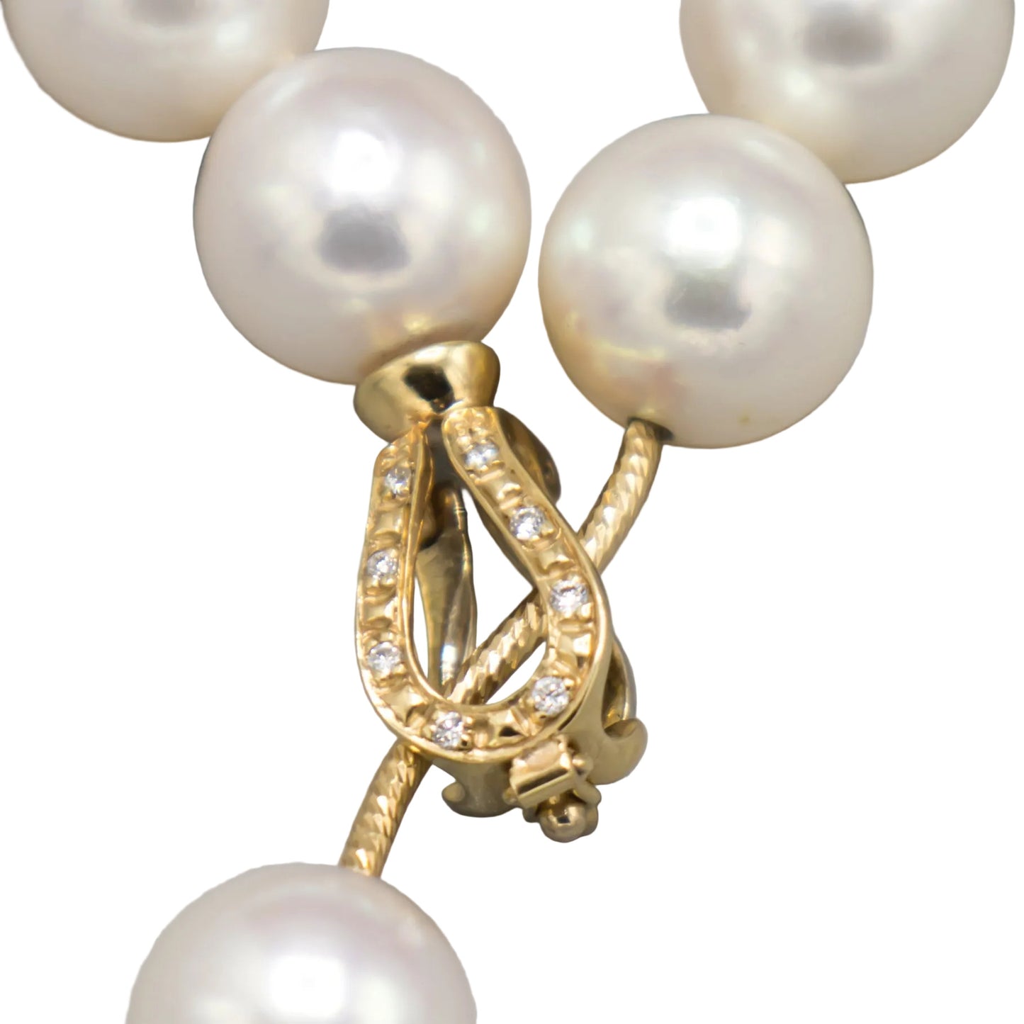 Close-up of the 14K yellow gold diamond-set lariat clasp on the Holly Zhang Akoya pearl necklace, shown fastened with diamonds set along the curved bail.