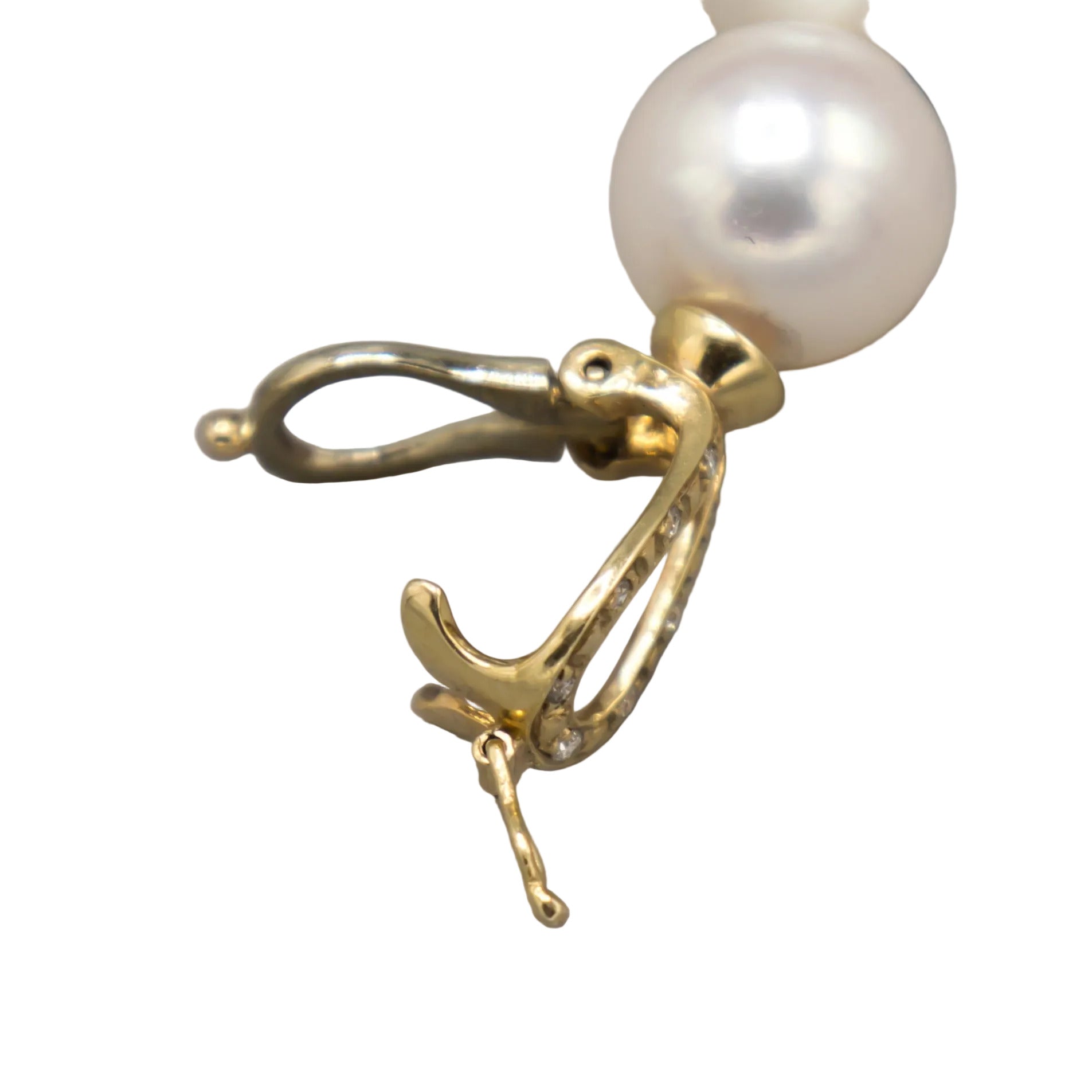 Detail view of the 14K yellow gold diamond-accented lariat clasp on the Holly Zhang Akoya pearl necklace, shown partially open with diamond pavé visible.