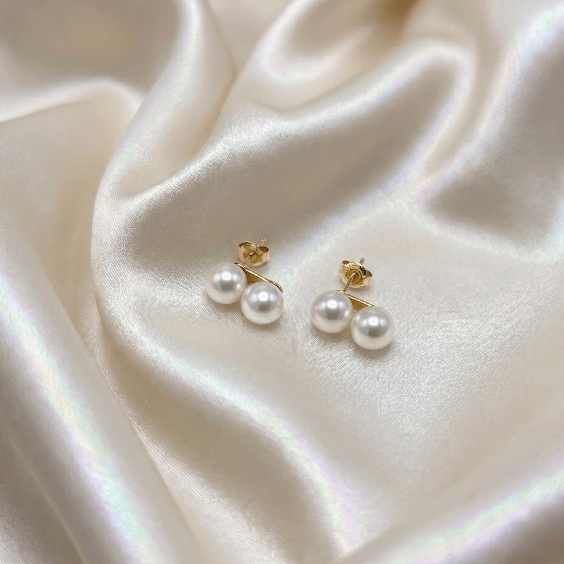 Holly Zhang 7.5–8mm Akoya pearl stud earrings on 18K gold, lifestyle shot