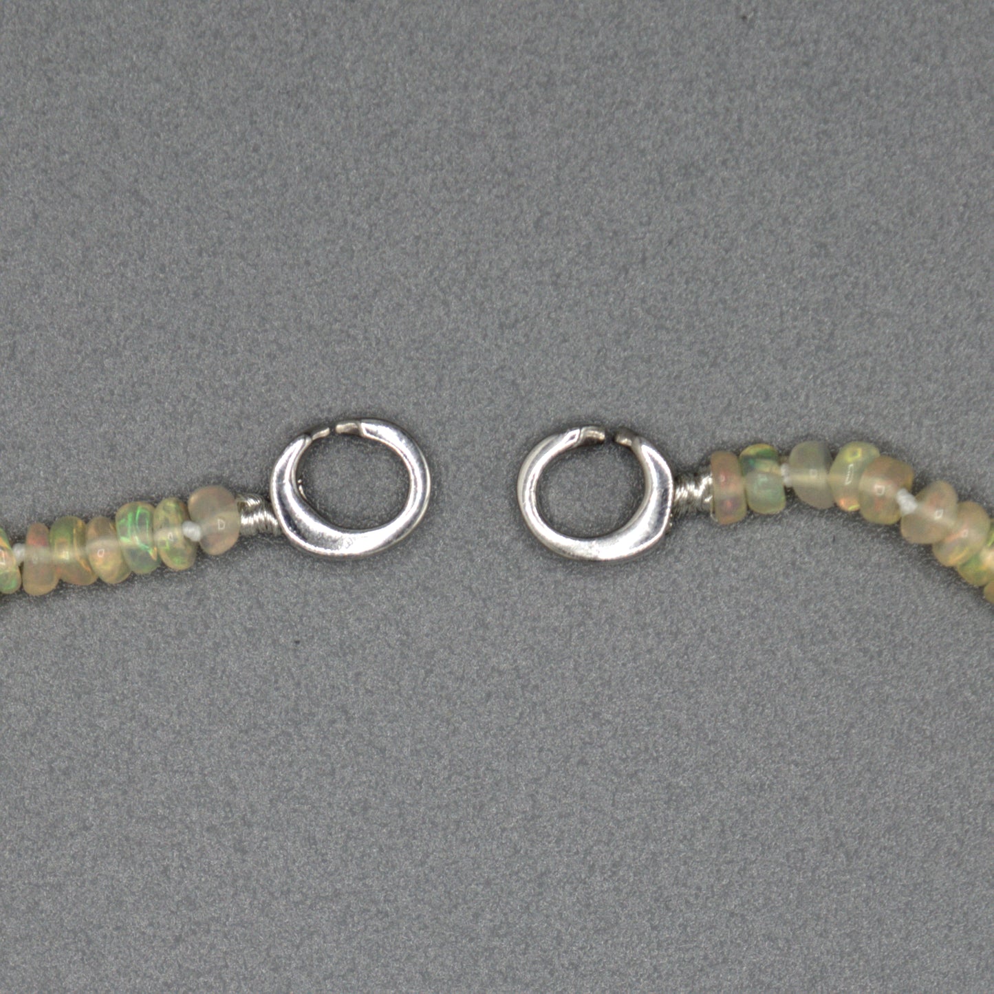 African opal necklace detail shot, sterling silver clasp and opal bead texture