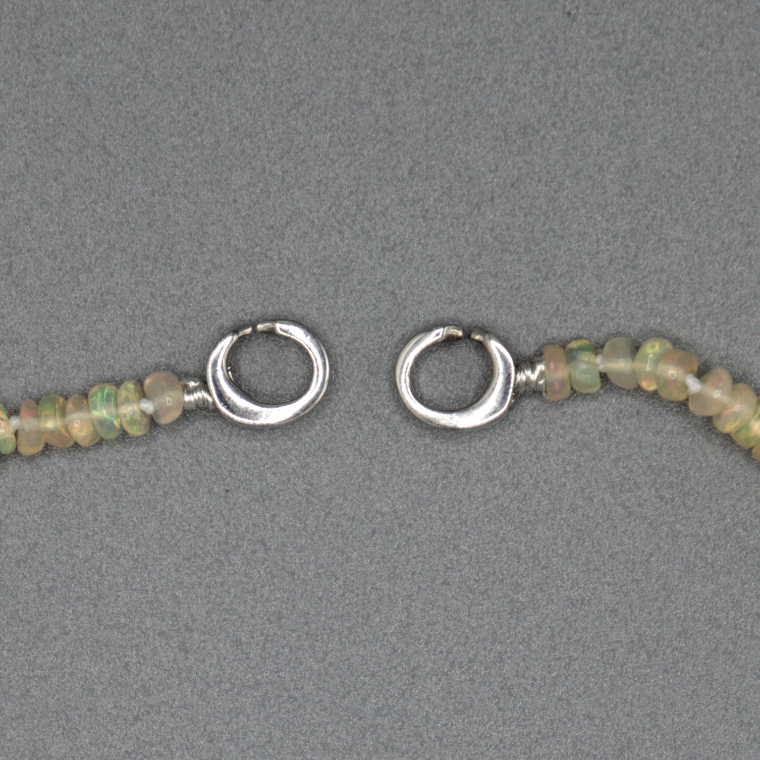 African opal necklace detail shot, sterling silver clasp and opal bead texture
