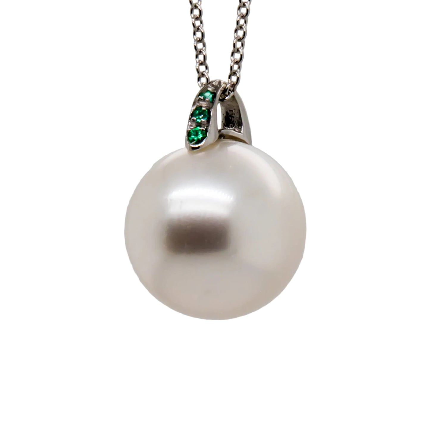 Close-up of 12.2mm Australian South Sea Pearl with emerald accents on 18K white gold pendant