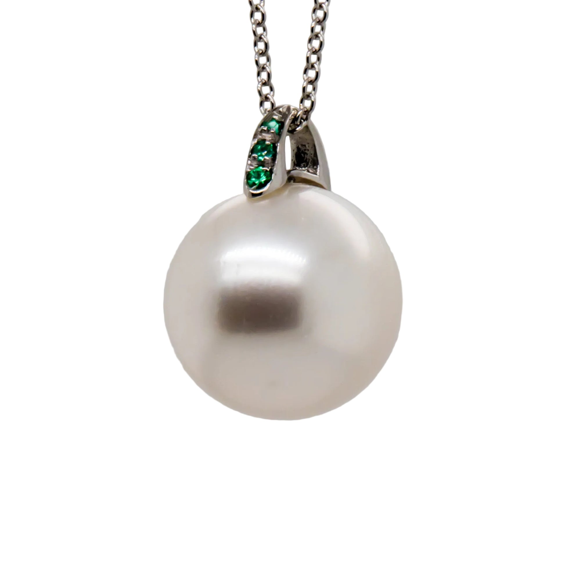 Close-up of 12.2mm Australian South Sea Pearl with emerald accents on 18K white gold pendant