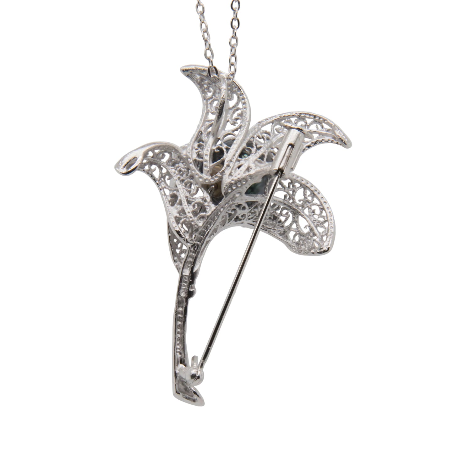 Silver filigree brooch on a white background