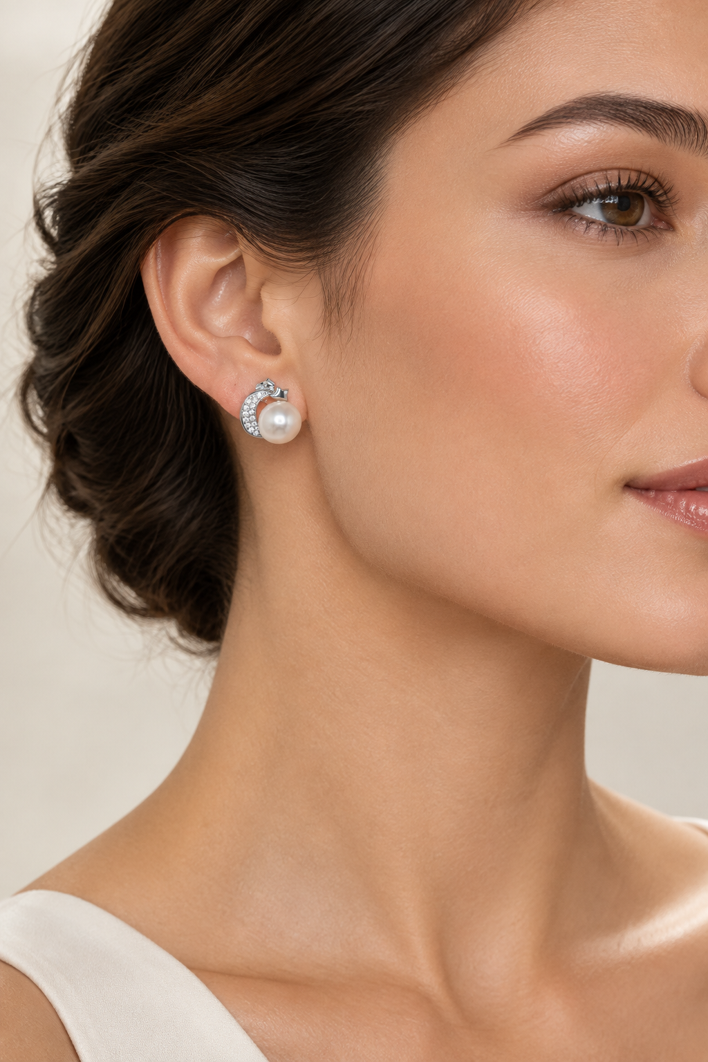 Model wearing freshwater pearl crescent moon stud earrings in sterling silver