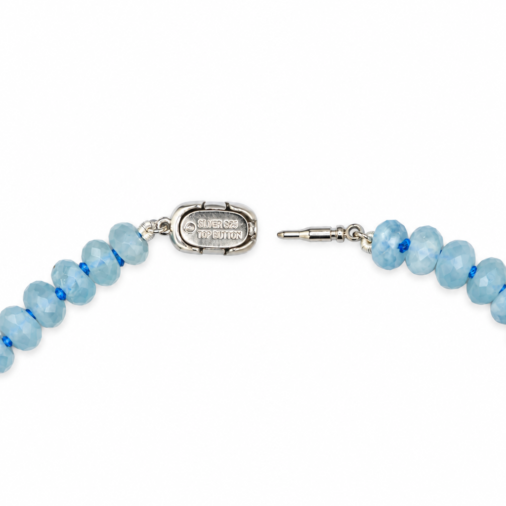 Open sterling silver needle clasp on the aquamarine and Tahitian pearl necklace, with blue faceted beads