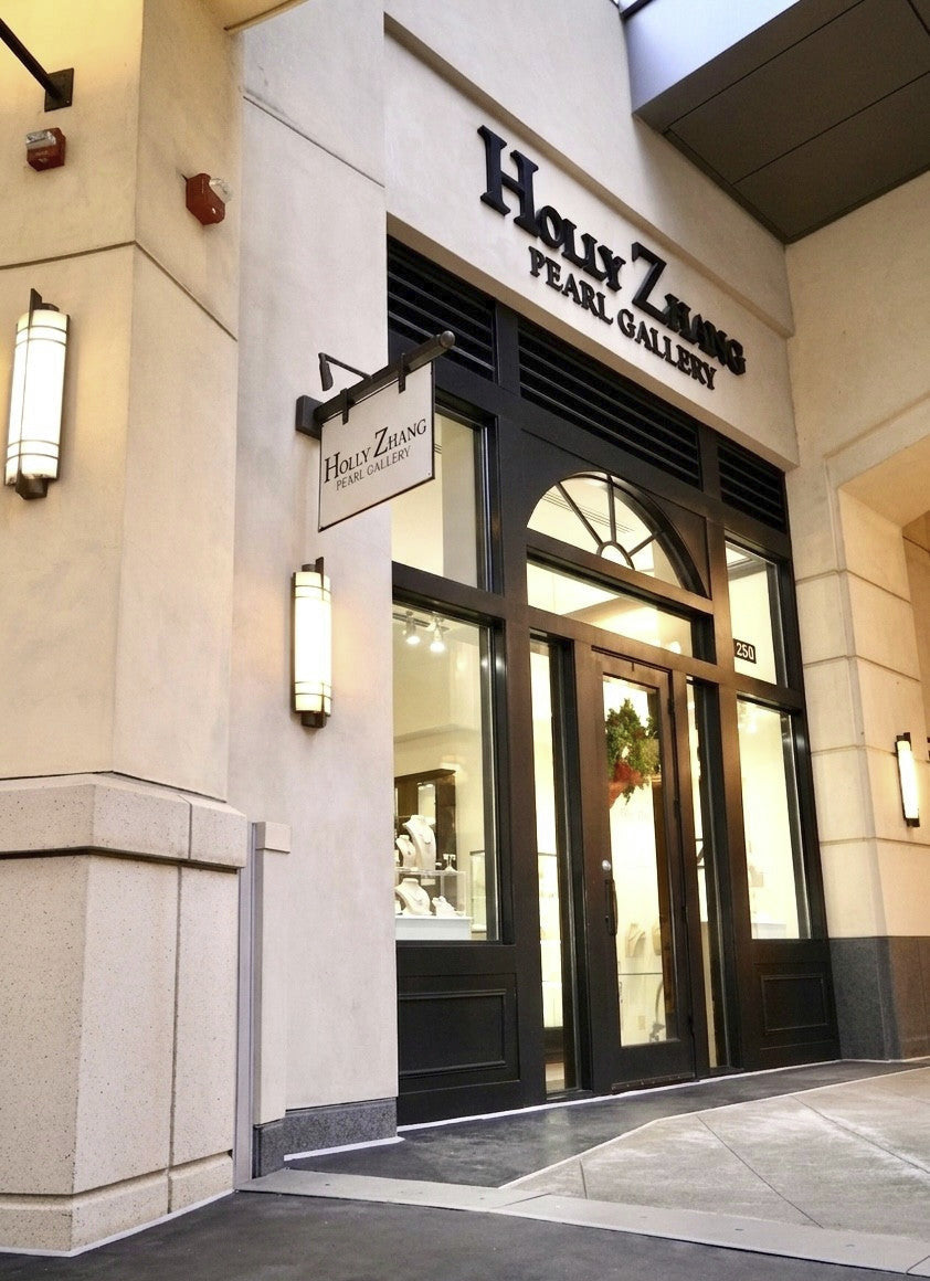 Storefront of Holly Zhang Pearl Gallery with glass doors and blade sign.