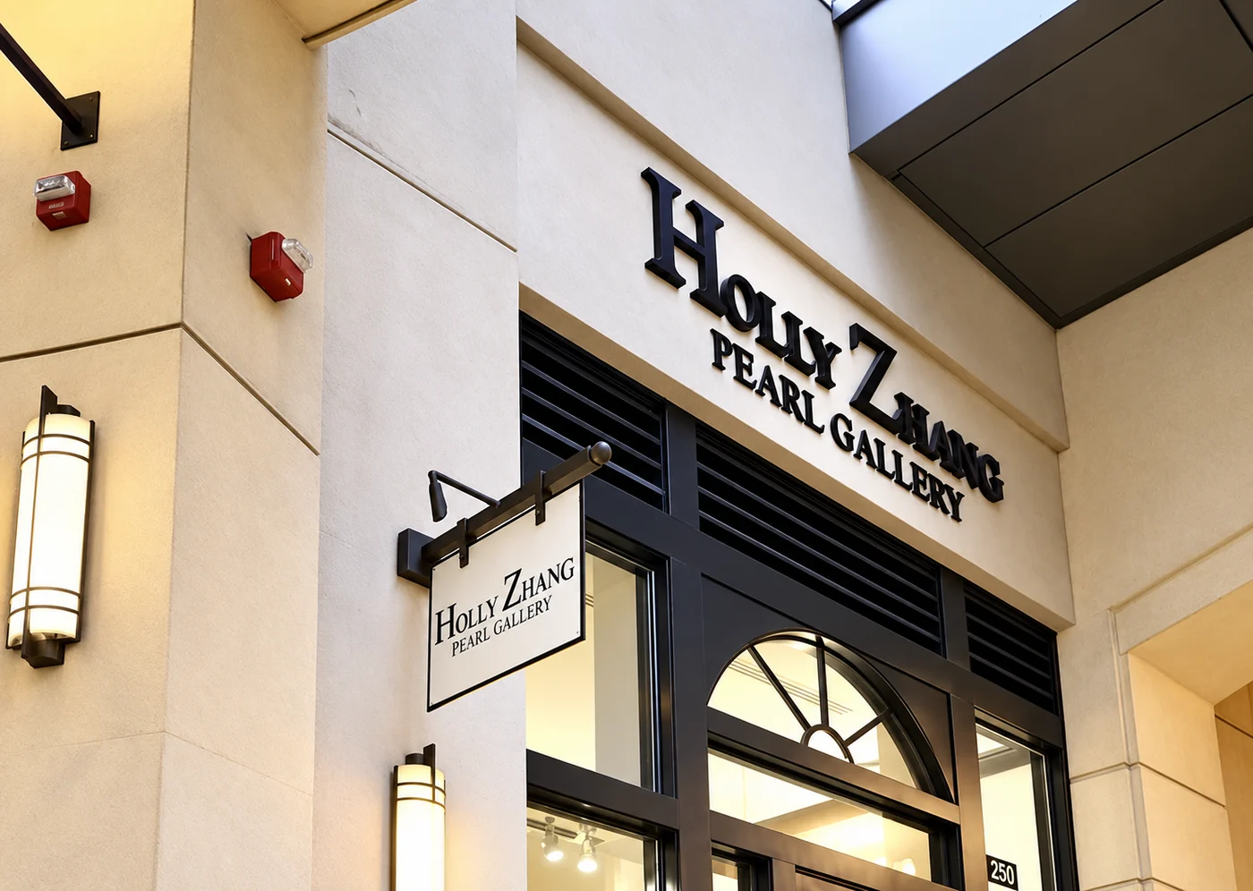 The Holly Zhang Pearl Gallery storefront in Bellevue, with its sign above the arched window