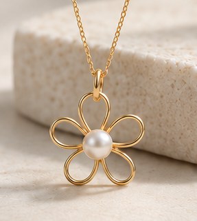 A gold wire flower pendant with a white pearl